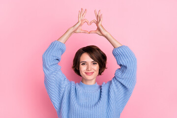 Sticker - Portrait of gorgeous positive lady arms make heart symbol above head isolated on pink color background