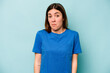 © Asier - Young caucasian woman isolated on blue background shrugs shoulders and open eyes confused.