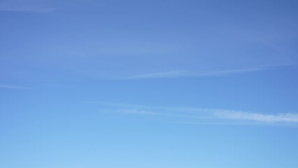 Wall Mural - 4k video time lapse of clear sunny blue sky. white soft small lines of soft clouds isolated on blue 