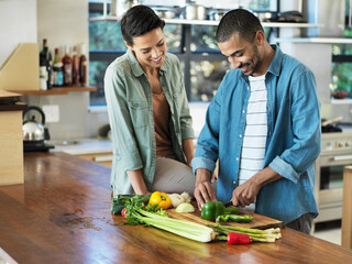 Poster - Youve got some mean dicing skills. Shot of a smiling young couple preparing a meal together in their kitchen.