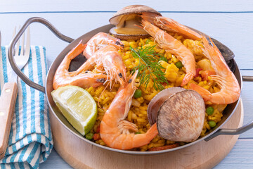 Wall Mural - top view of a paella in a dish on a table