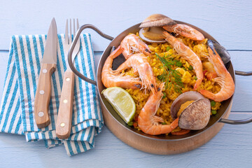 Wall Mural - top view of a paella in a dish on a table