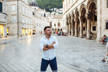 Handsome sexy man in white shirt in old european city. Summer in Croatia. Dubrovnik city