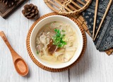 Fototapeta Na sufit - flat food soup in a dish with wooden soup isolated on wood table side view taiwan food