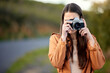 © Daiyaan P/peopleimages.com - Ill be traveling many miles and taking many many pictures. Shot of a young woman using her camera while spending time outdoors.