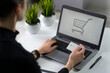 © marekfromrzeszow - Businesswoman paying for online purchases, uses a laptop, holding a banking card in hand and typing on the keyboard.  Free space to add logo or text.