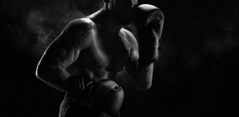 Wall Mural - Noname image of a kickboxer on a dark background. The concept of mixed martial arts.