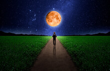 Lonely Man Walking Down A Long Road With Full Moon