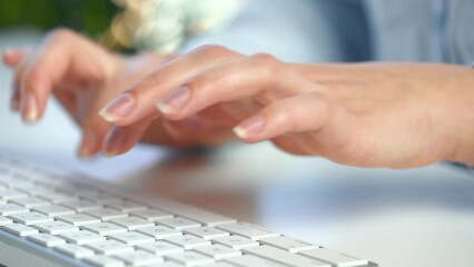 Female hands busy working on computer keyboard for sending emails and surf on a web browser