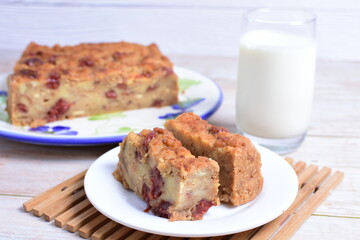 Sticker - Fluffy bread cake with guava flavor accompanied by a glass of milk on a wooden background