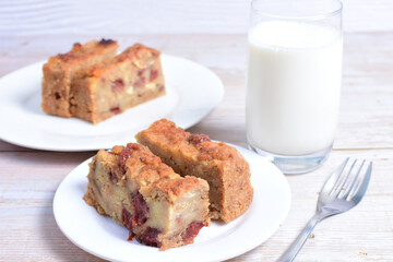 Sticker - Fluffy bread cake with guava flavor accompanied by a glass of milk on a wooden background