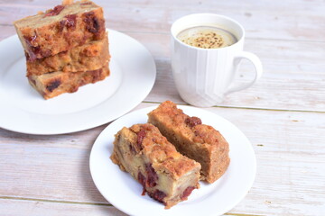 Sticker - Fluffy bread cake with guava flavor accompanied by a cup of coffee on a wooden background