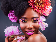 All You Need To Do Is To Add A Little Pink. Studio Shot Of A Beautiful Young Woman Posing With Flowers In Her Hair.
