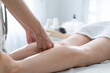© Kawee - Close up of young client girl feel relaxed during leg massage with oil