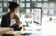 © wichayada - Cheerful asian woman working in office use computer with copy space. Business owner people sme freelance online marketing e-commerce telemarketing, work from home concept