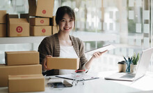 Startup Small Business Entrepreneur SME, Asian Woman Packing Cloth In Box. Portrait Young Asian Small Business Owner Home Office, Online Sell Marketing Delivery, SME E-commerce Telemarketing Concept