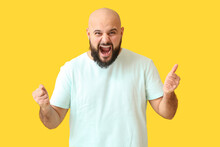 Portrait Of Happy Bald Man Showing Thumb-up On Yellow Background