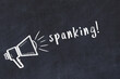 Chalk sketch of loudspeaker and inscription spanking