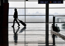 The Silhouettes Of People In An Airport.
