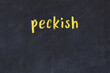 College chalk desk with the word peckish written on in