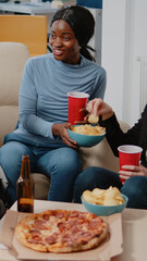 Wall Mural - People enjoying drinks and snacks after work for leisure. Smiling coworkers with chips, pizza, and beer celebrating party after hours at office. Colleagues having fun and entertainment