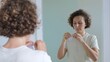 © Sia - A woman takes an additional means for performing hygienic treatment of teeth with high-quality safe dental floss and begins to perform the procedure of brushing teeth. Daily dental care.