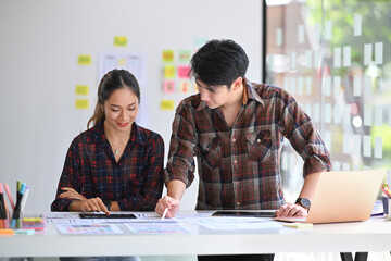 Wall Mural - shot of website developer team planning application development for mobile phone at creative workpla