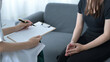 © Prathankarnpap - Professional physician wearing white coat talking with patient and signing medical paper at appointment visit in clinic.