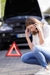 young female driver calling the roadside service