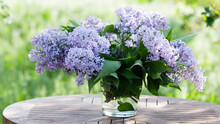 Bouquet Of Lilacs On The Table In The Summer Garden