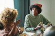 © AnnaStills - Teenage boy talking to his mother while they sitting at table and having dinner at home