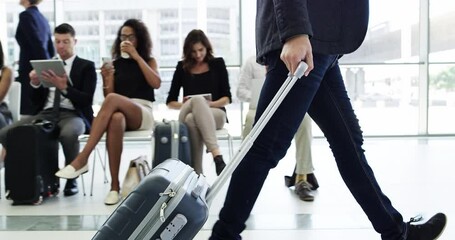 Aufkleber - Ambition takes you places. Young business man on business trip walking with his luggage in front of a group of waiting people. Travelling businessman headed towards terminal in a modern airport
