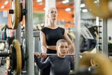 A Young Woman Trains In A Gym With A Female Coach. Deadlift.
