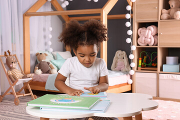 Canvas Print - African American girl reading book at home