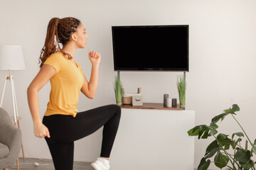 Wall Mural - Sporty Woman Doing Leg Exercise During Workout At Home