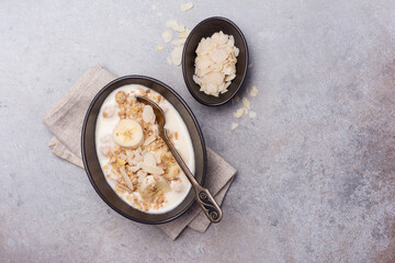 Wall Mural - Healthy breakfast of granola with fresh banana, nuts and yogurt