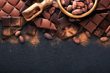 Chocolate . Composition of cocoa powder, grated and bean cocoa bars and pieces of different milk and dark chocolate on black background. Baking Chocolate Texture. Top view with copy space. Mock up.