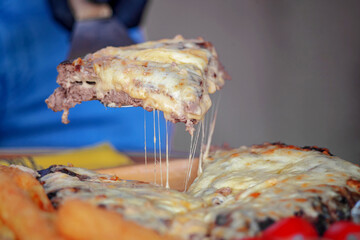 Poster - Beautiful shot of a pizza with two layers of meat and cheese