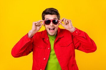 Sticker - Photo of hooray young guy hold eyewear wear red shirt isolated on yellow color background