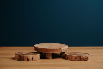 Wall Mural - Closeup shot of cut tree logs on a tree with a dark blue background