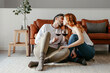 © ADDICTIVE STOCK - Loving couple with wineglasses kissing on floor