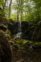 Wall Mural - Beautiful shot of a waterfall covered with moss