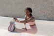 © Renata Hamuda - African American female athlete stretching her legs and preparing to run before exercise