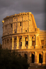 Poster - Vertical shot of the famous Roman Coliseum illuminated by the sunset sun