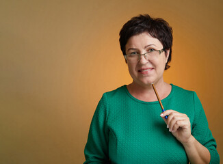 Wall Mural - Portrait of Caucasian Mature female teacher standing on background