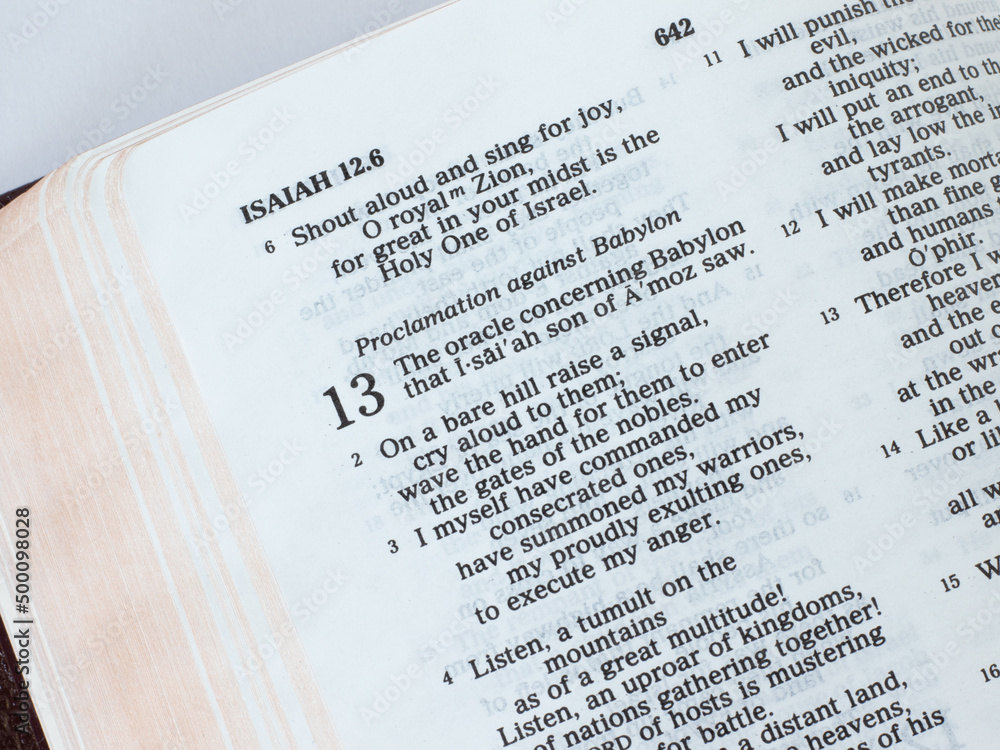 Open Holy Bible Book, prophet Isaiah prophecy for the fall of Babylon ...