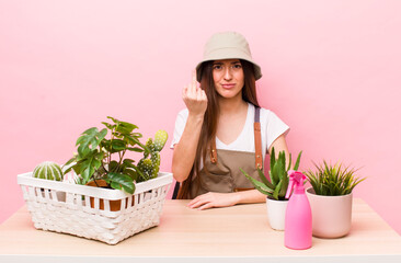 Wall Mural - hispanic pretty woman feeling angry, annoyed, rebellious and aggressive. plants and gardering concept