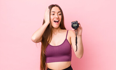 Poster - hispanic pretty woman feeling happy, excited and surprised. fitness and stopwatch concept