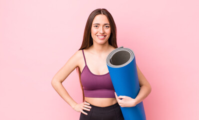 Poster - hispanic pretty woman smiling happily with a hand on hip and confident. fitness and yoga concept