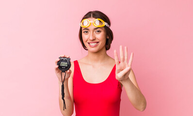 Poster - hispanic pretty woman smiling and looking friendly, showing number four. swimmer and timer concept